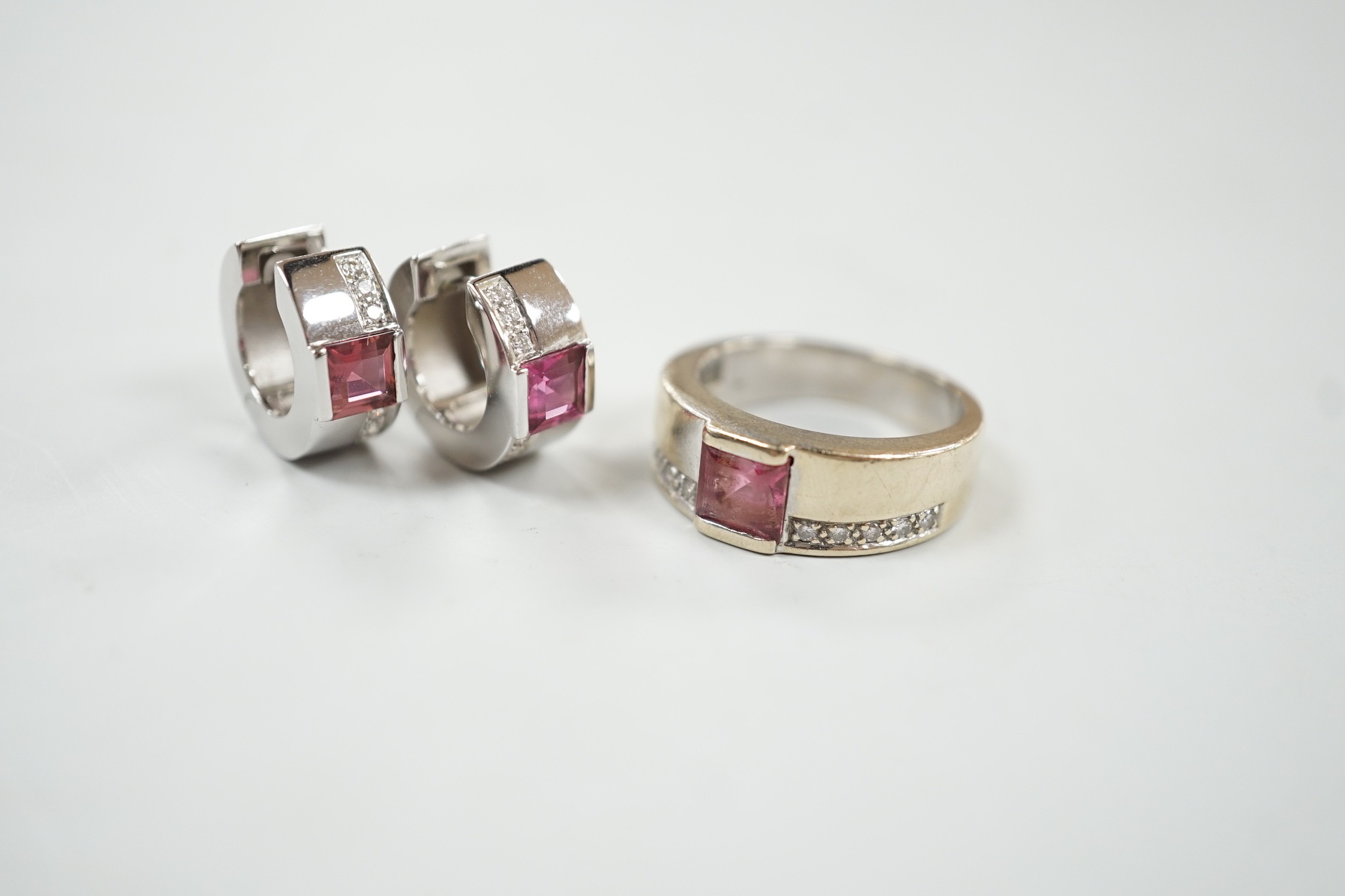 A modern 18ct white gold, pink tourmaline and diamond chip set suite of jewellery, comprising a ring, size O and pair of matching hoop earrings, 15mm, gross weight 16.8 grams.